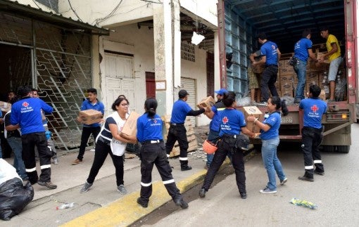 Ecuador earthquake - unloading a truck of Clorox bleach